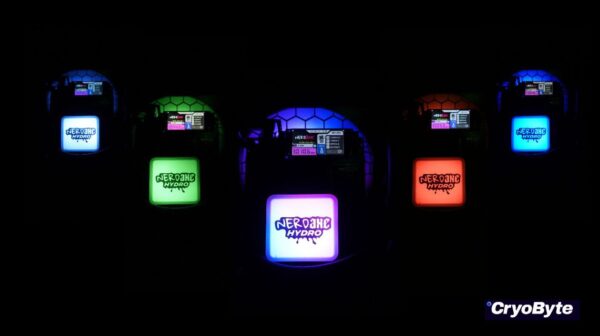 Five NerdQaxe+ Hydro bitcoin solo miners glowing in vibrant LED colors—blue, green, purple, red, and cyan—against a black background, showcasing their customizable RGB lighting.