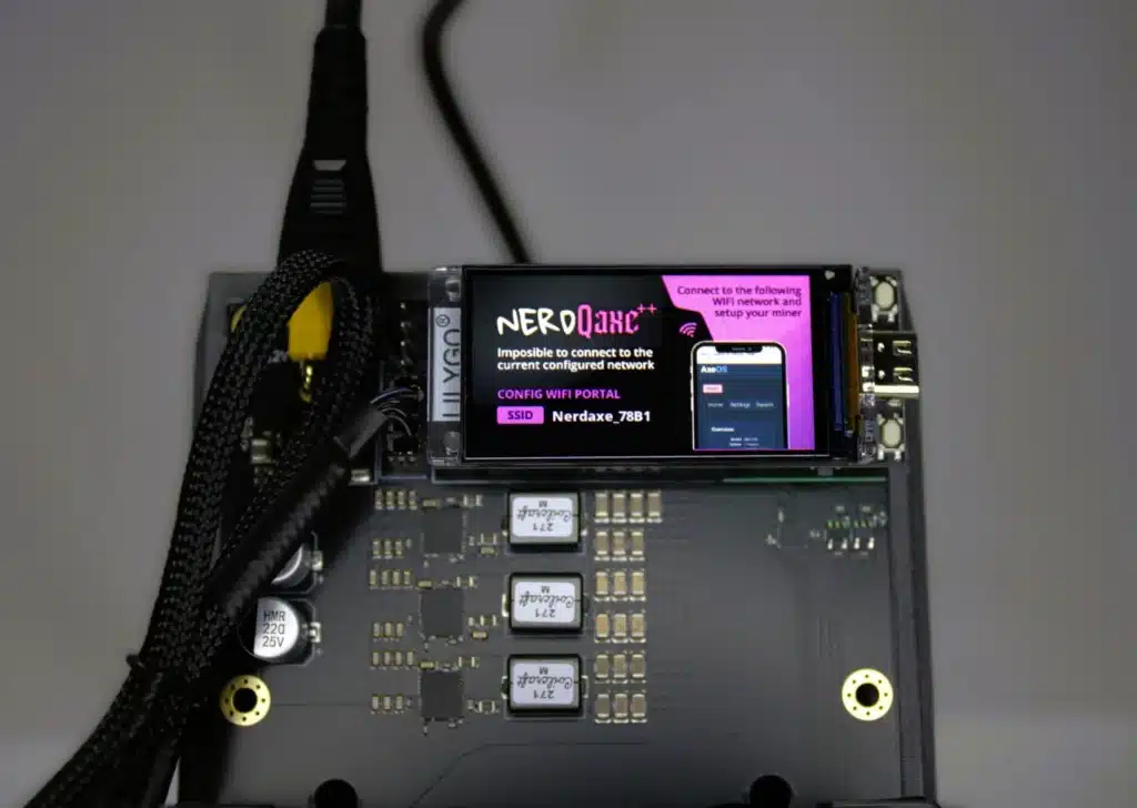 Close-up of a NerdQaxe++ Bitcoin solo-miner displaying its purple onboarding screen that instructs users to connect to the temporary โNerdaxe_78B1โ Wi-Fi SSID for first-time configuration.