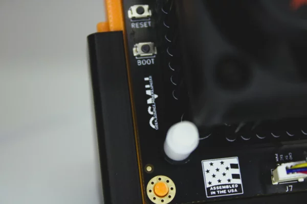 Close up of Bitaxe Gamma Bitcoin solo miner featuring the Dark Horse heatsink upgrade reset and boot buttons and Assembled in USA badge