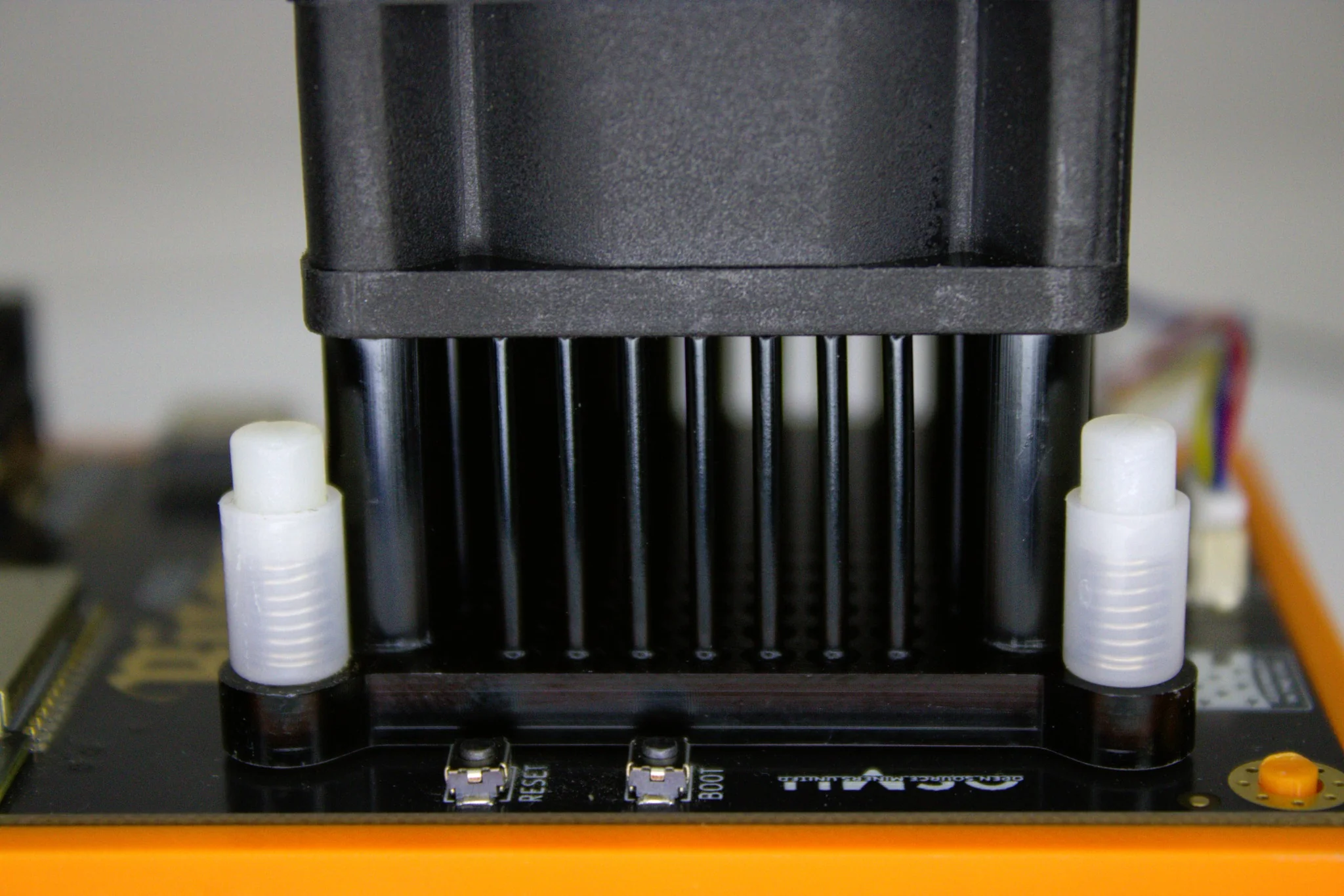 Front view of Bitaxe Gamma solo miner with Dark Horse pin-fin heatsink and fan shroud mounted above reset and boot buttons