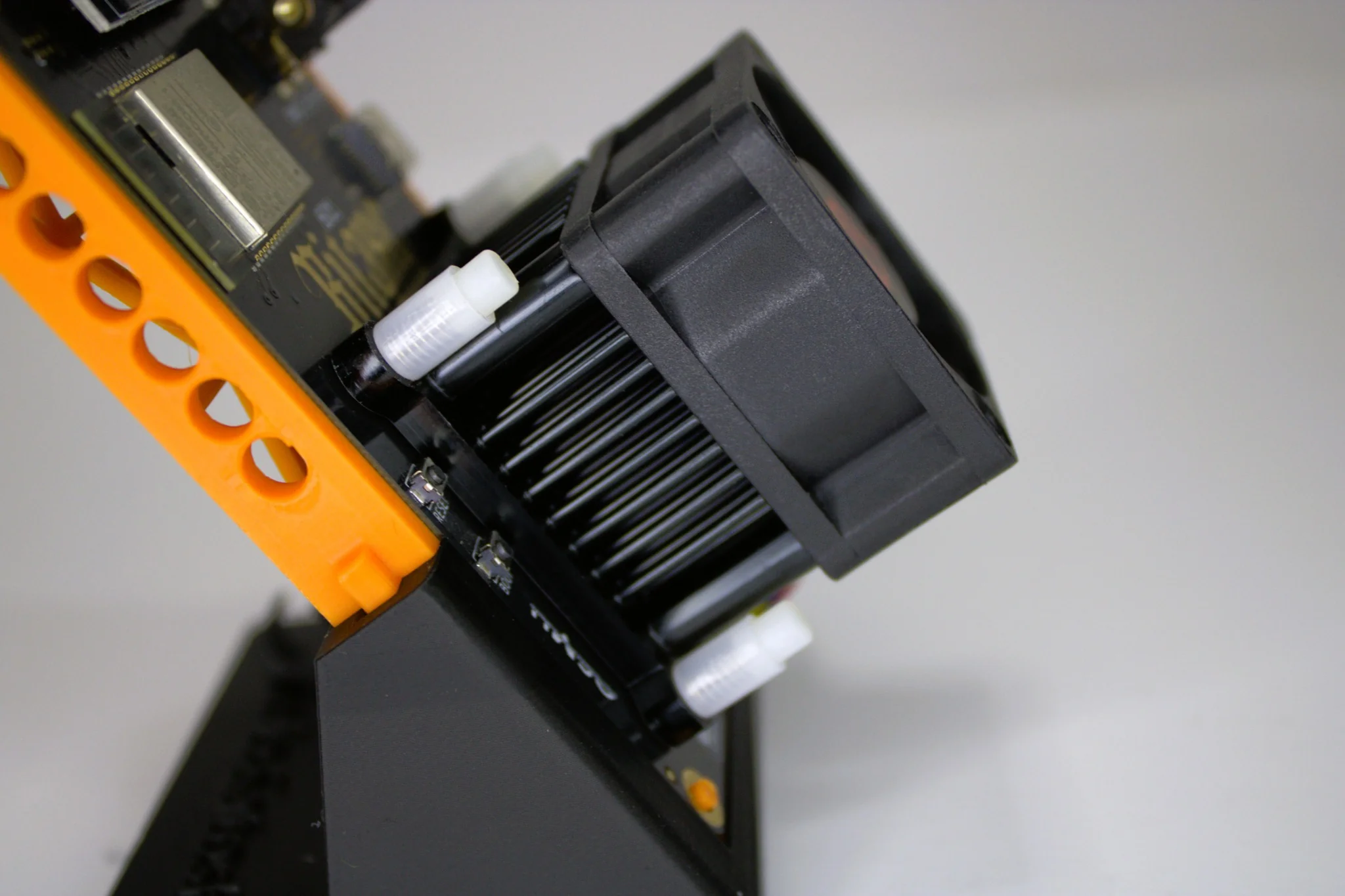 Angled side profile of Bitaxe Gamma solo miner showing Dark Horse heatsink and cooling fan on printed stand