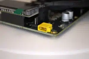 Close-up of NerdQaxe++ Rev-6 yellow XT30 power connector on the PCB edge.