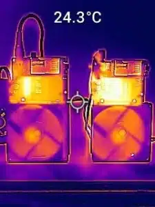 Thermal image comparing front sides of NerdQaxe++ Rev-6 (left) and Rev-5 (right), showing cooler temperatures on Rev-6.