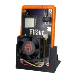 Bitaxe Supra version 403 Bitcoin miner with an orange Solo Satoshi case, visible circuit board, and front-facing cooling fan with a red anarchy logo, displayed at an angle on a black stand.