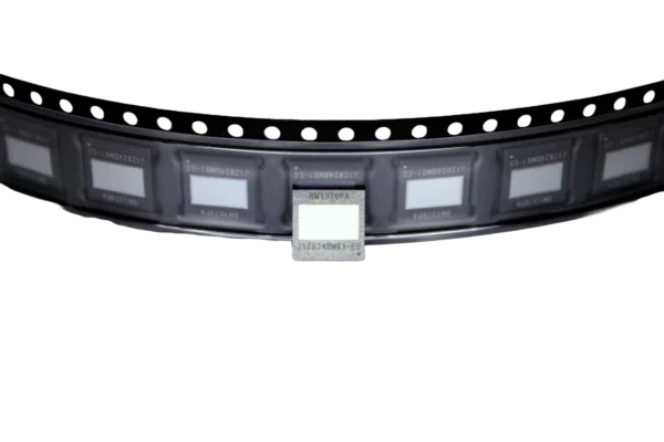 Reel of BM1370PA ASIC chips with one chip exposed, used in Bitaxe, Nerdaxe, and NerdQaxe DIY Bitcoin miners