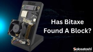 Bitaxe Gamma 602 solo Bitcoin miner on 3D printed stand with fan and BM1370 ASIC chip, featured image for Has Bitaxe Found a Block article by Solo Satoshi.