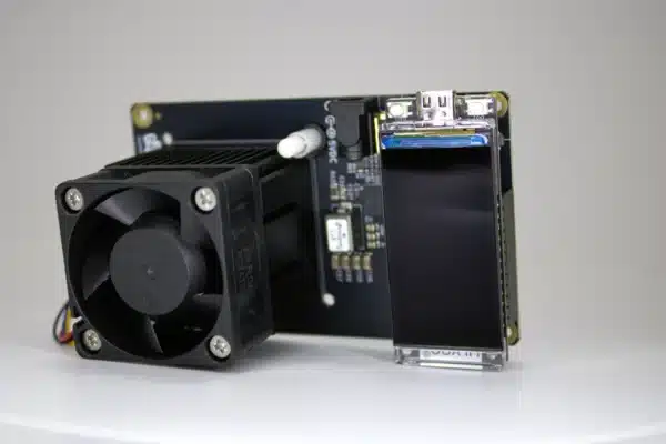 “Side-profile of NerdAxe Gamma Bitcoin solo-miner board showing compact heatsink, 40 mm cooling fan, and OLED display module”