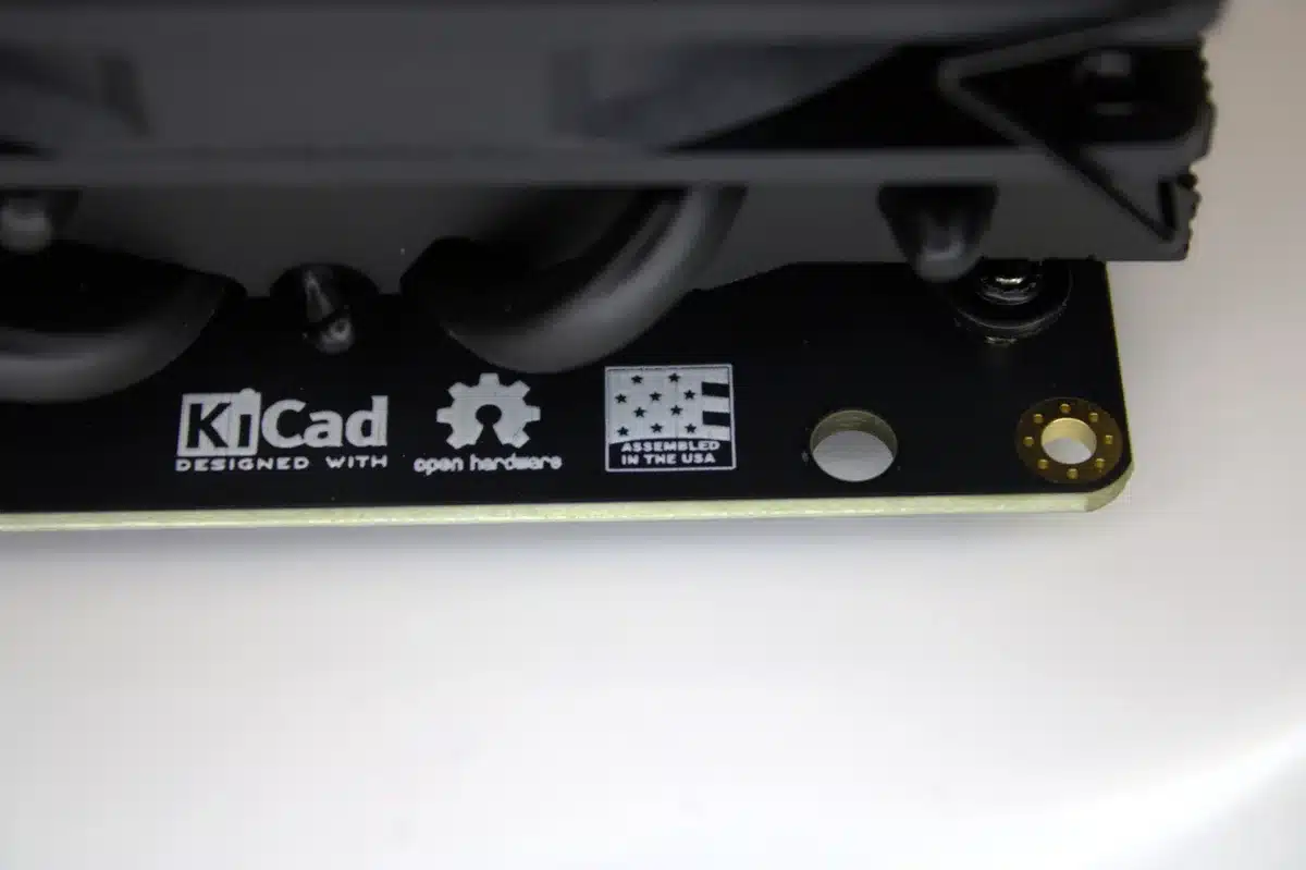KiCad “Designed With” and “Assembled in the USA” badges on NerdQaxe++ Rev 6 PCB beneath black heatsink
