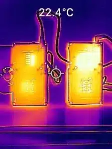 FLIR thermal image of NerdQaxe++ Rev 6 (left) vs. older Rev 5 (right) viewed from underside, illustrating cooler power traces on new board