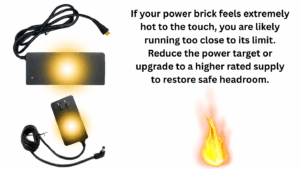 Graphic showing two power supplies with glowing hot spots and a safety message warning that an extremely hot power brick may indicate the miner is running too close to the power supply’s limit.