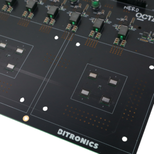 Close-up of NerdOctaxe Gamma PCB showing yellow XT30 power connector, green fuse, open hardware logo, capacitors, VRM components, and braided fan cables on black circuit board