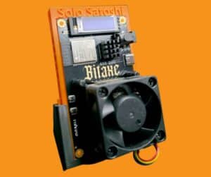 Bitaxe Duo 650 dual-chip Bitcoin solo miner on orange Solo Satoshi stand showing Dark Horse heatsink, 40mm fan, OLED display with live mining stats, ESP32-S3 module, and 650 DUO Bitaxe branding